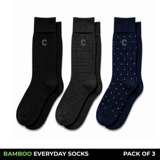 Three pairs of black bamboo everyday socks shown on a white background, with a black banner at the bottom reading 'BAMBOO EVERYDAY SOCKS PACK OF 3'. The left pair has thin red pinstripes, the middle pair is solid black, and the right pair has small white dot accents.