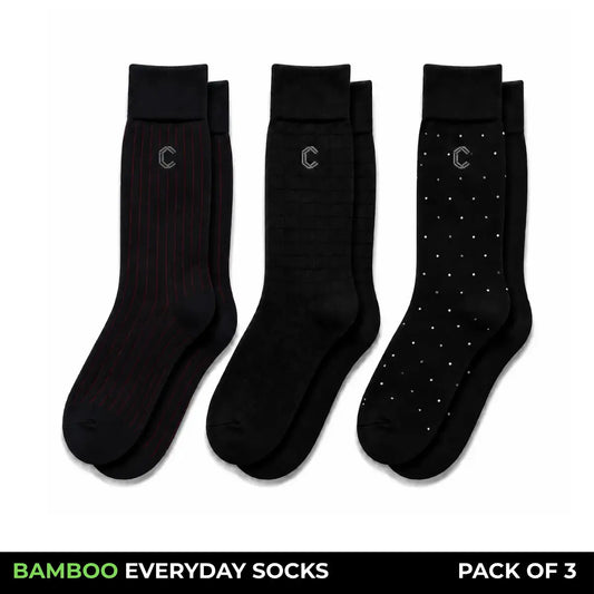 Three pairs of black bamboo everyday socks shown on a white background, with a black banner at the bottom reading 'BAMBOO EVERYDAY SOCKS PACK OF 3'. The left pair has thin red pinstripes, the middle pair is solid black, and the right pair has small white dot accents.